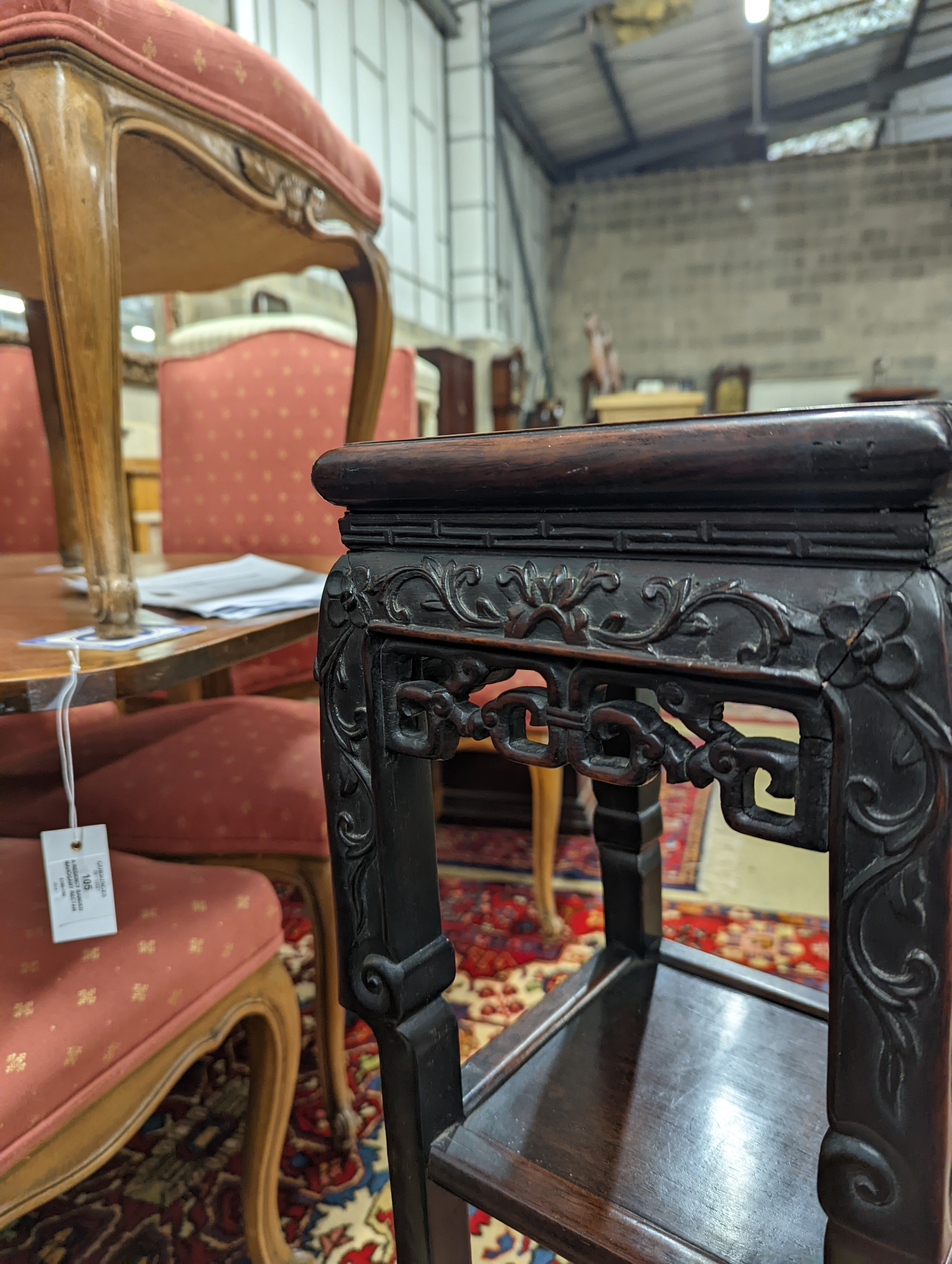 A Chinese carved hardwood three tier jardiniere stand, marble inset, width 22cm, depth 22cm, height 82cm